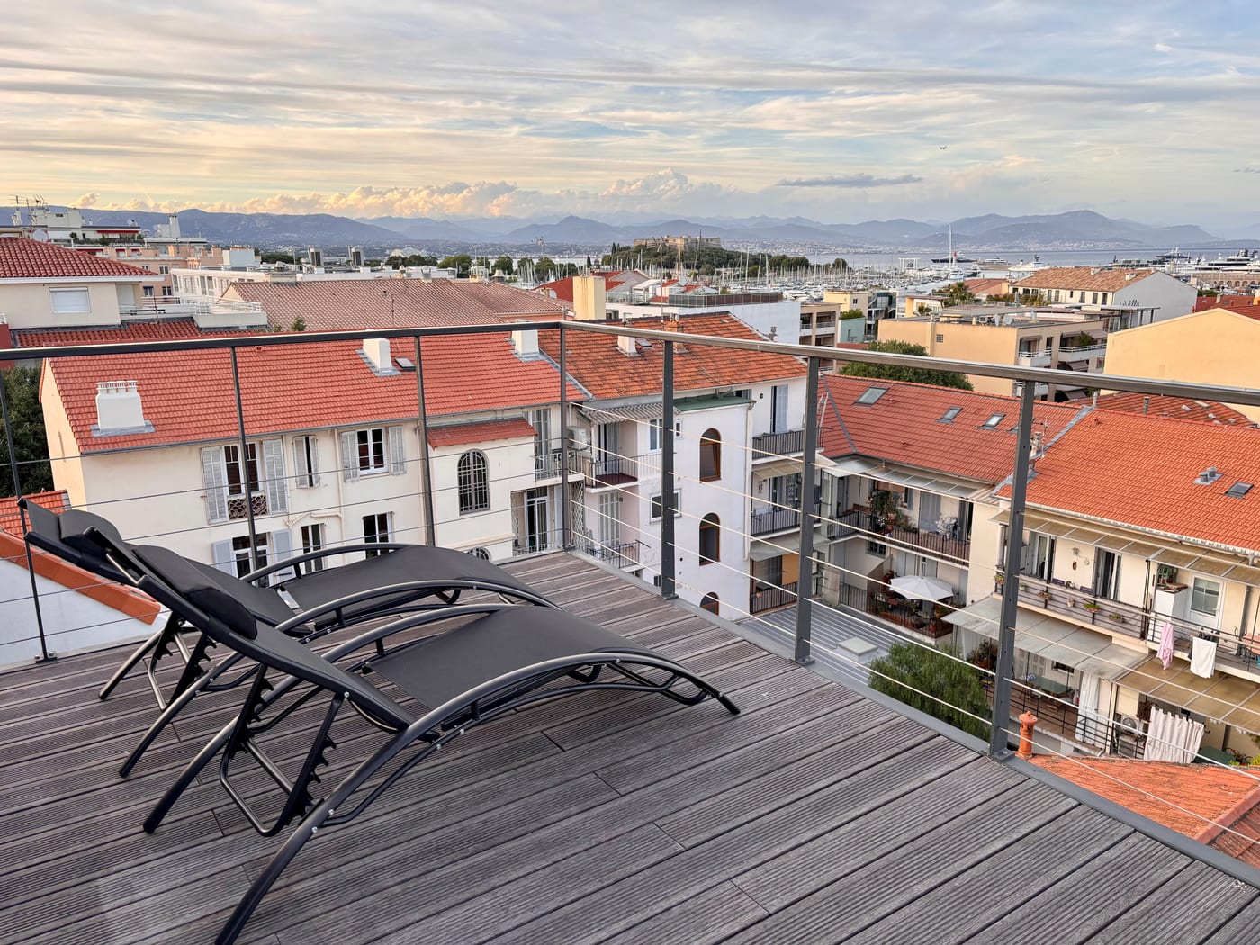 Rooftop terrace with harbour and mountain views