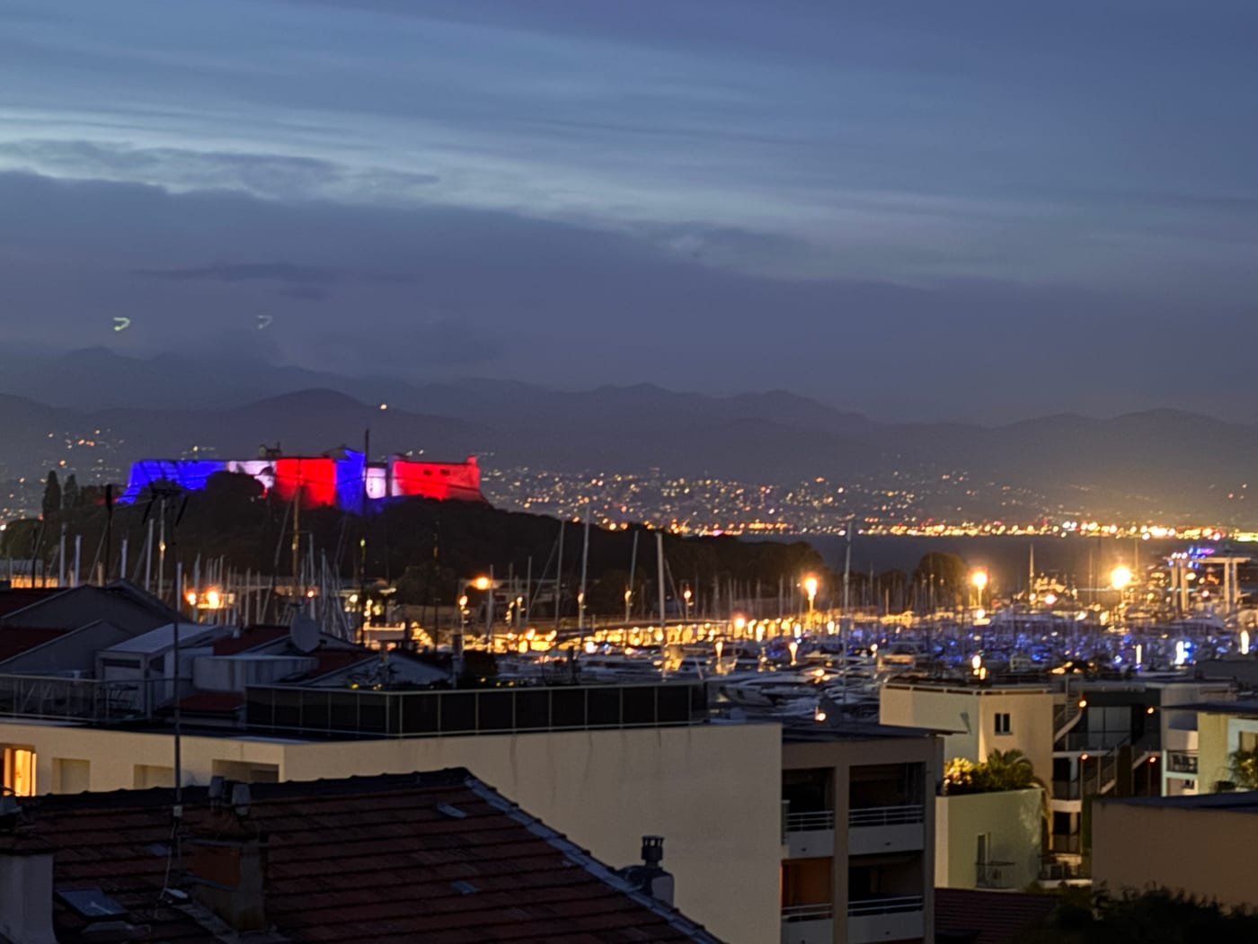 Fort Carré illuminated above Port Vauban at night